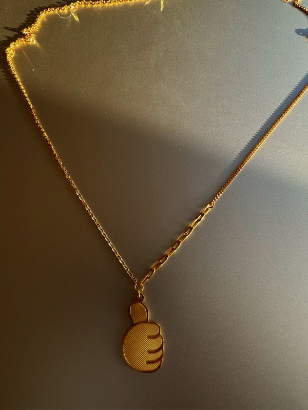 24k gold necklace with thumb up